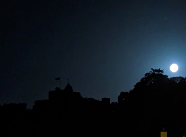 Silhouette of Dunster Castle in the full moon