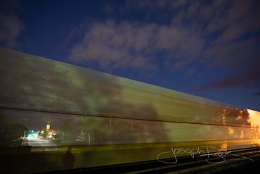 Surreal photo of Downtown Bryon Ohio through a train in motion.