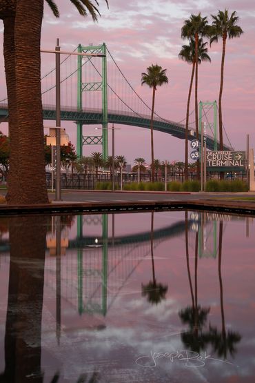 San Pedro, California. Beautiful sunrise pink sky reflection of the Vincent Thomas Bridge.
