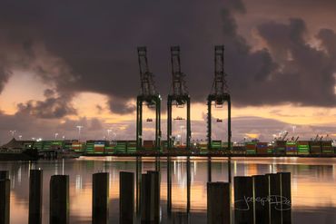 San Pedro, California. Incredible photo of Ship to Shore cranes with peach colored sunrise clouds.