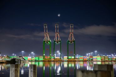 San Pedro, California. Incredible photo of Ship to Shore cranes with a bright crescent moon above.