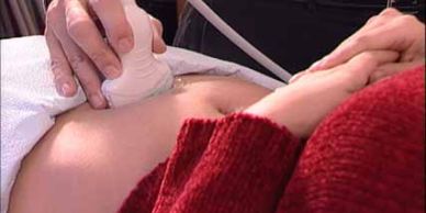 Ultrasound being performed on a pregnant belly.