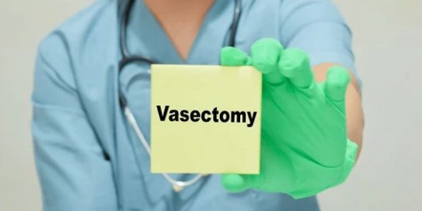 Doctor holding a note saying "Vasectomy".