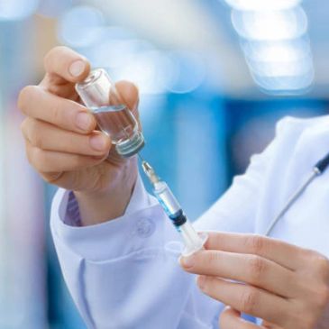 Healthcare professional preparing a cortisone injection.