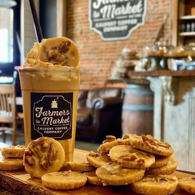 Iced coffee with pecan cookies on a wooden board.