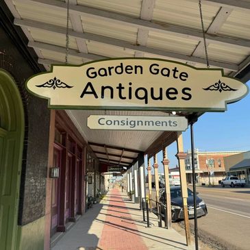 Sign for Garden Gate Antiques and Consignments outside a storefront.