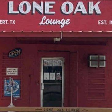 Entrance of Lone Oak Lounge with red facade and open sign.