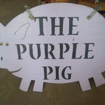 The Purple Pig of Calvert Logo on their exterior sign