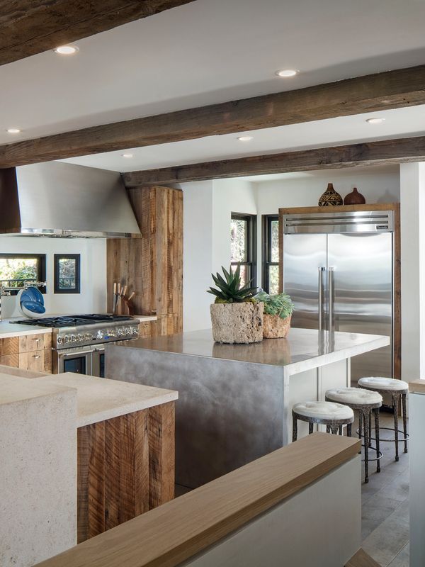 Modern kitchen with wooden beams and stainless steel appliances.