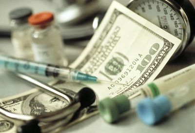 Medication needle with money and test tubes