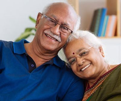 Retired happy Indian couple with heads touching