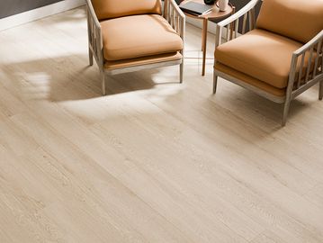Two chairs with a small table on a wooden floor.