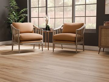 Two cushioned wooden armchairs with a small table between them.