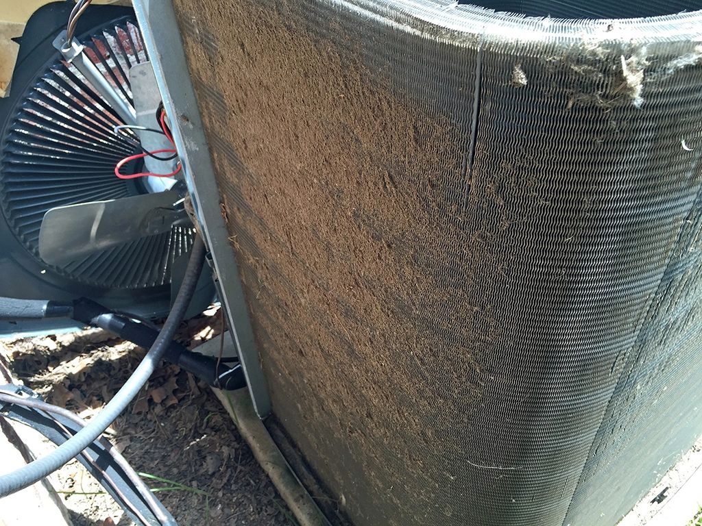 A dirty outdoor AC unit that needs to be cleaned out.