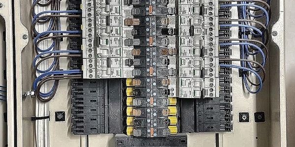 Open electrical panel with neatly organized circuit breakers and wiring.