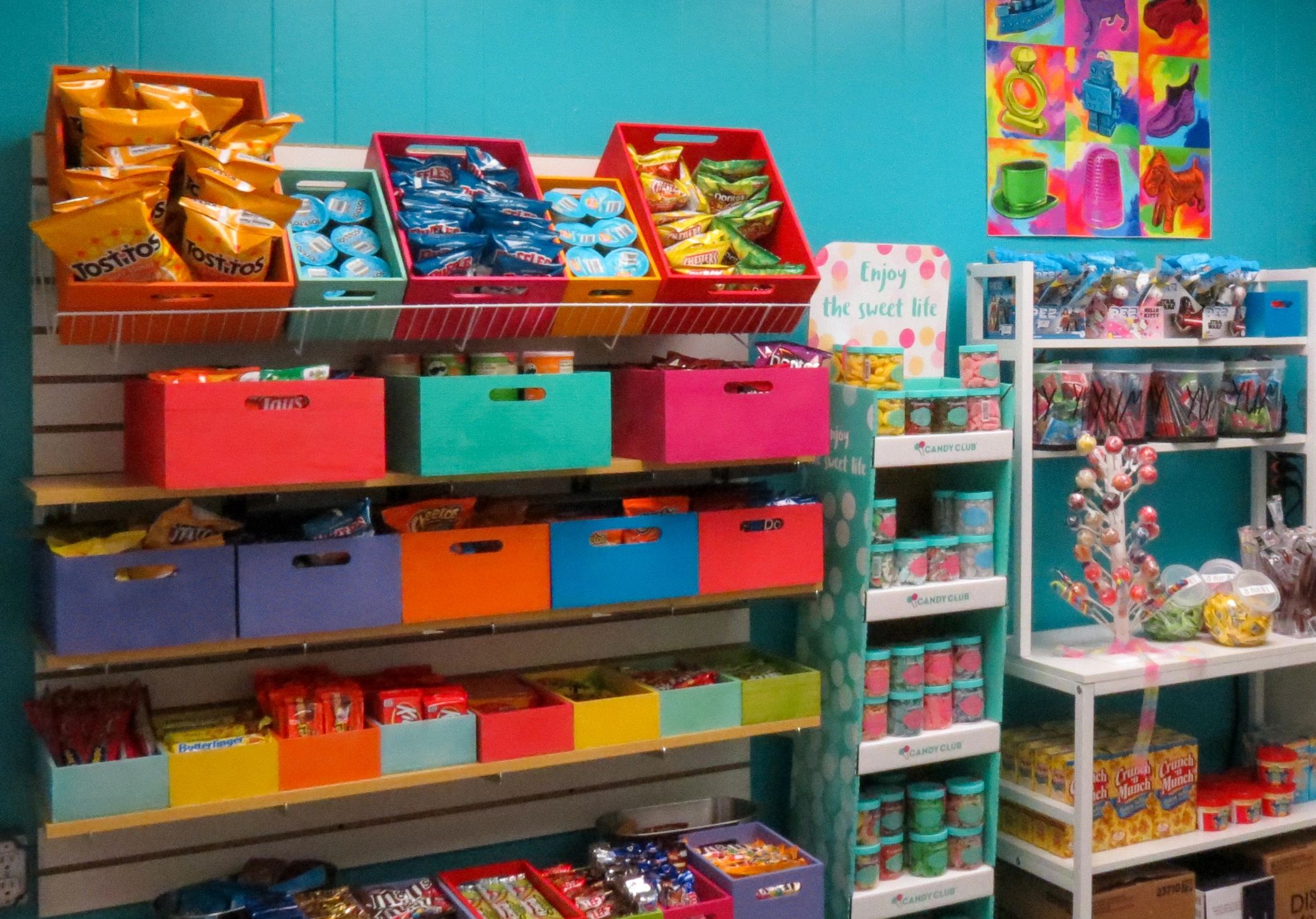 Shelf with colorful containers full of snacks