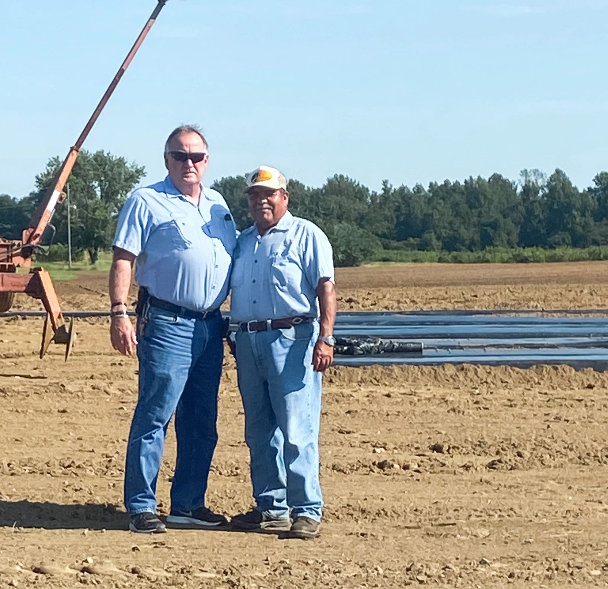 Tim Minor and Abelardo Enriquez in strawberry field