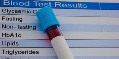 Blood test results form with a blood sample vial on it.