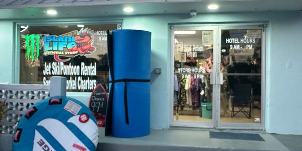 Entrance to Island Life General Store with rental and hotel hours.