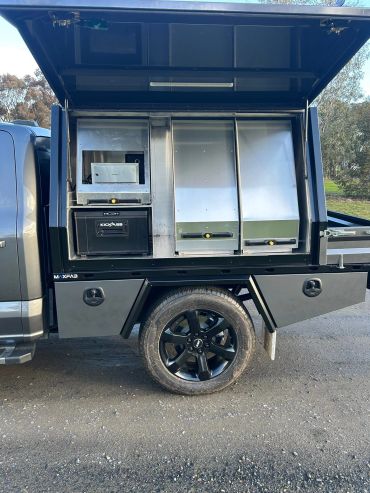 Truck with open storage compartments and equipment.