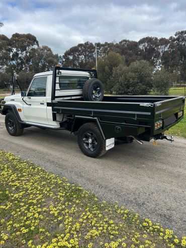 White and black pickup truck parked on a road.