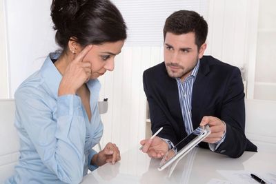 Man explaining something to a woman.