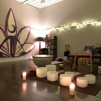 A serene yoga or meditation room with candles and soft lighting.