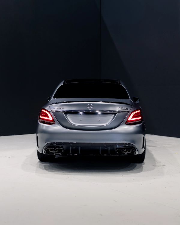 Rear view of a silver Mercedes-Benz C 63 AMG car.
