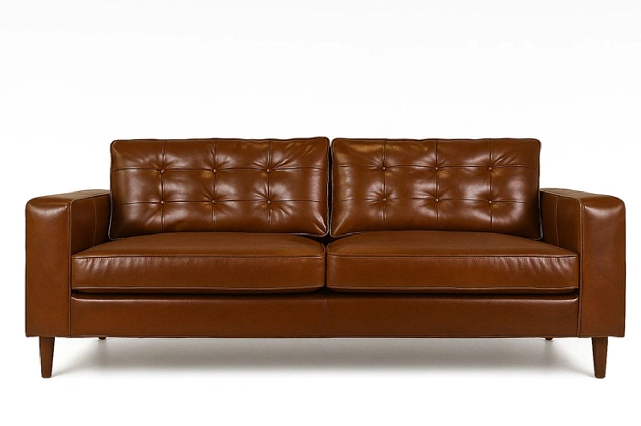 Brown leather tufted sofa with wooden legs.