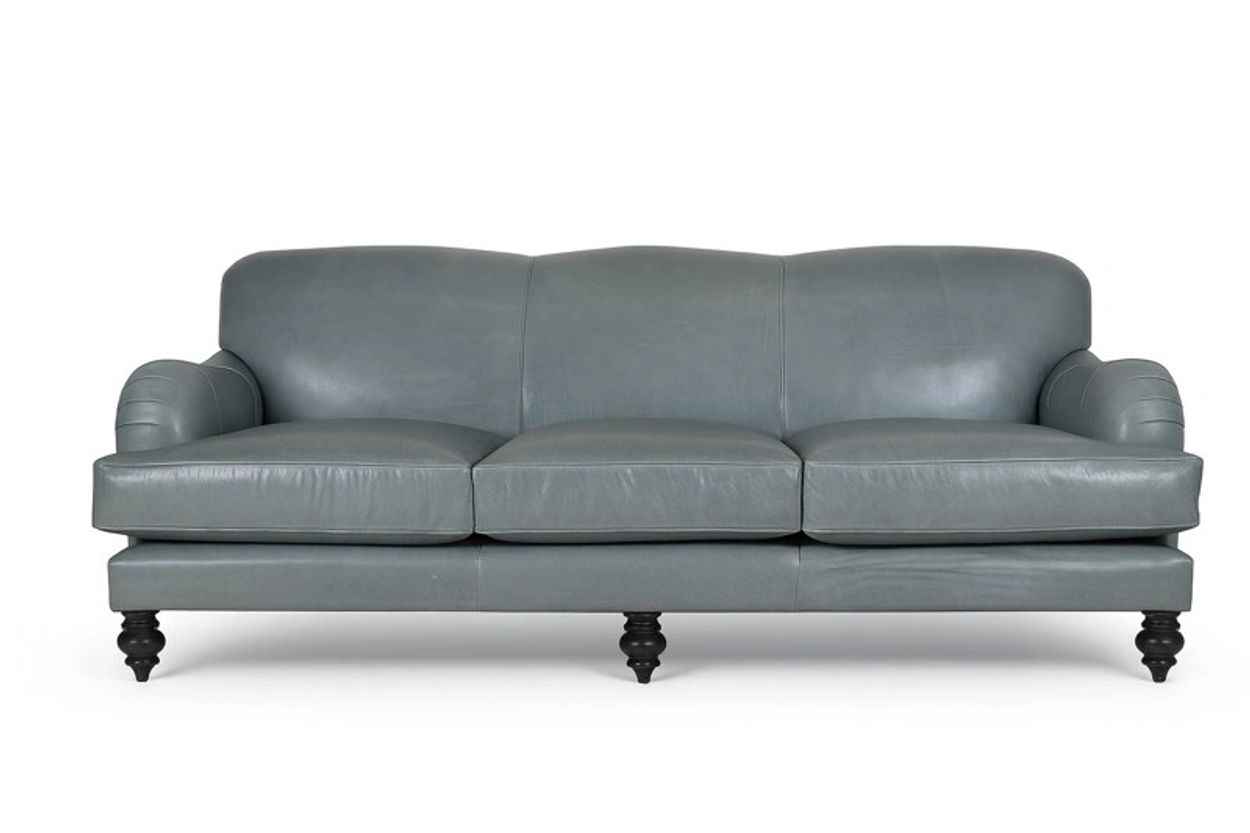 A sleek gray leather sofa with three cushions and black wooden legs.