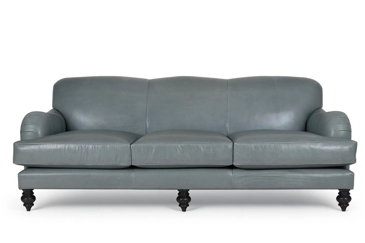 A sleek gray leather sofa with three cushions and black wooden legs.