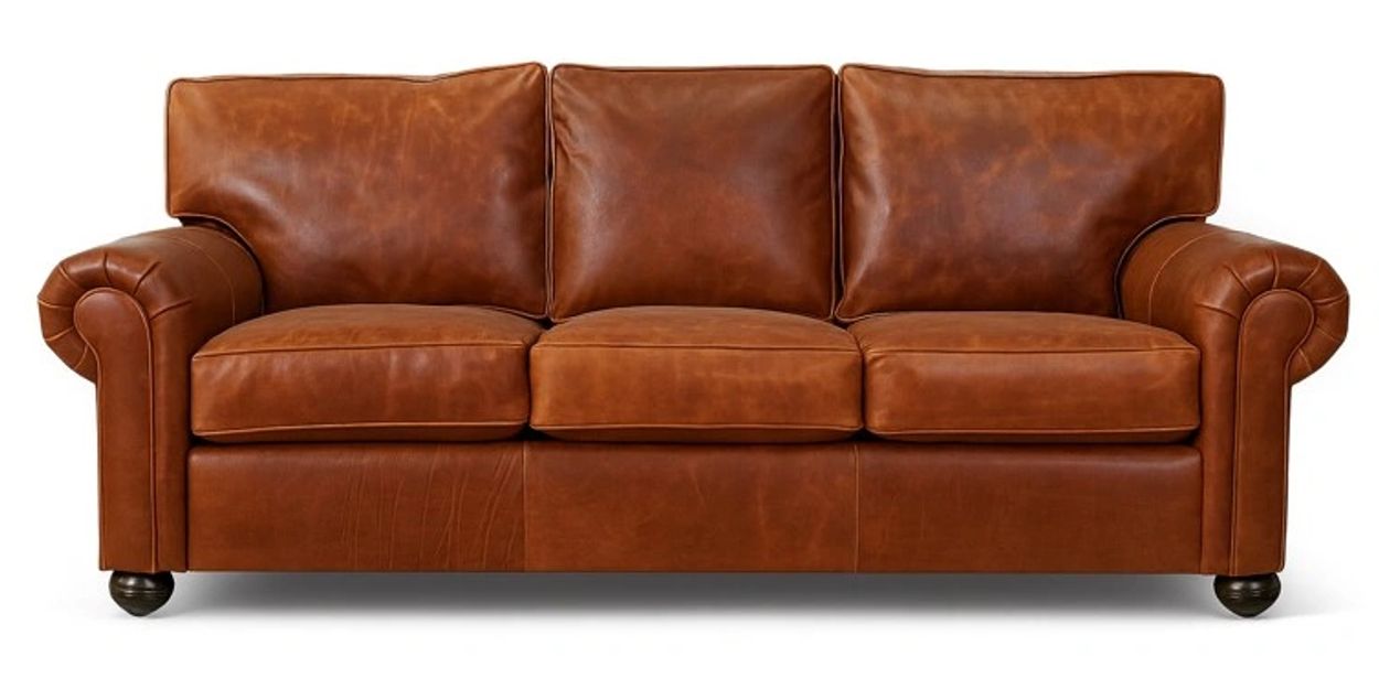 Classic brown leather sofa with rolled arms and three cushions.