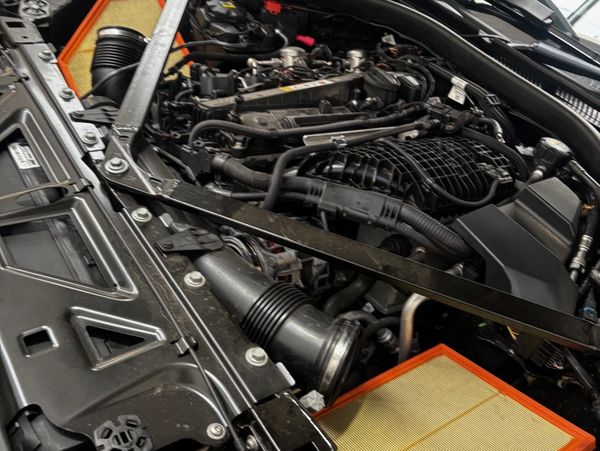 Detailed view of a car engine with visible air filters and components.