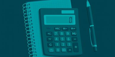 Calculator, notebook, and pen on a dark surface.