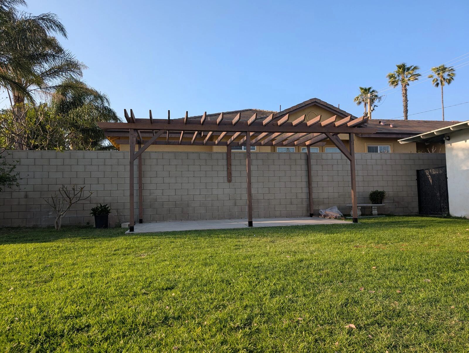 New wood pergola over a backyard patio in Fontana