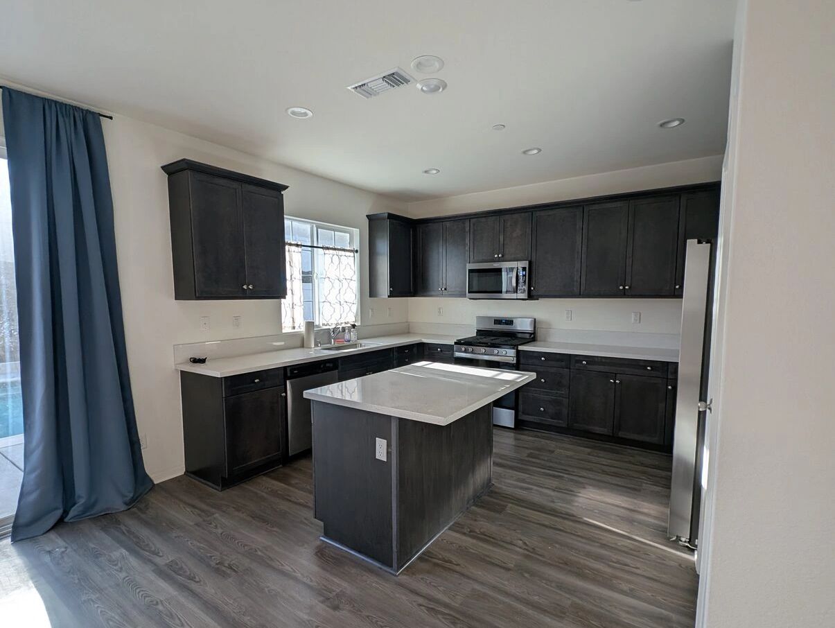 Vacant rental with a kitchen island and new plank flooring in Rancho Cucamonga