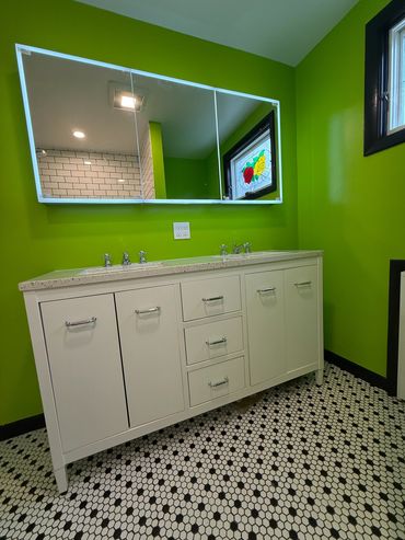 Bathroom with lime green walls and white vanity.
