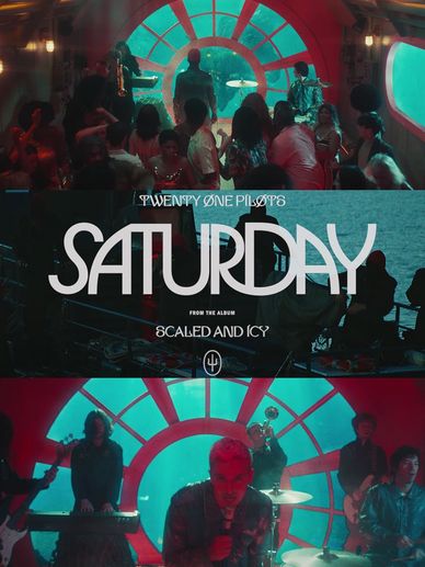 Twenty One Pilots performing 'Saturday' in a vibrant underwater-themed set.