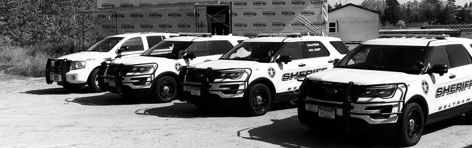 Four sheriff patrol SUVs lined up outdoors.