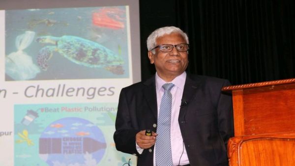 Man giving a presentation on plastic pollution challenges.