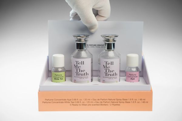Perfume kit with two main bottles and two concentrates.