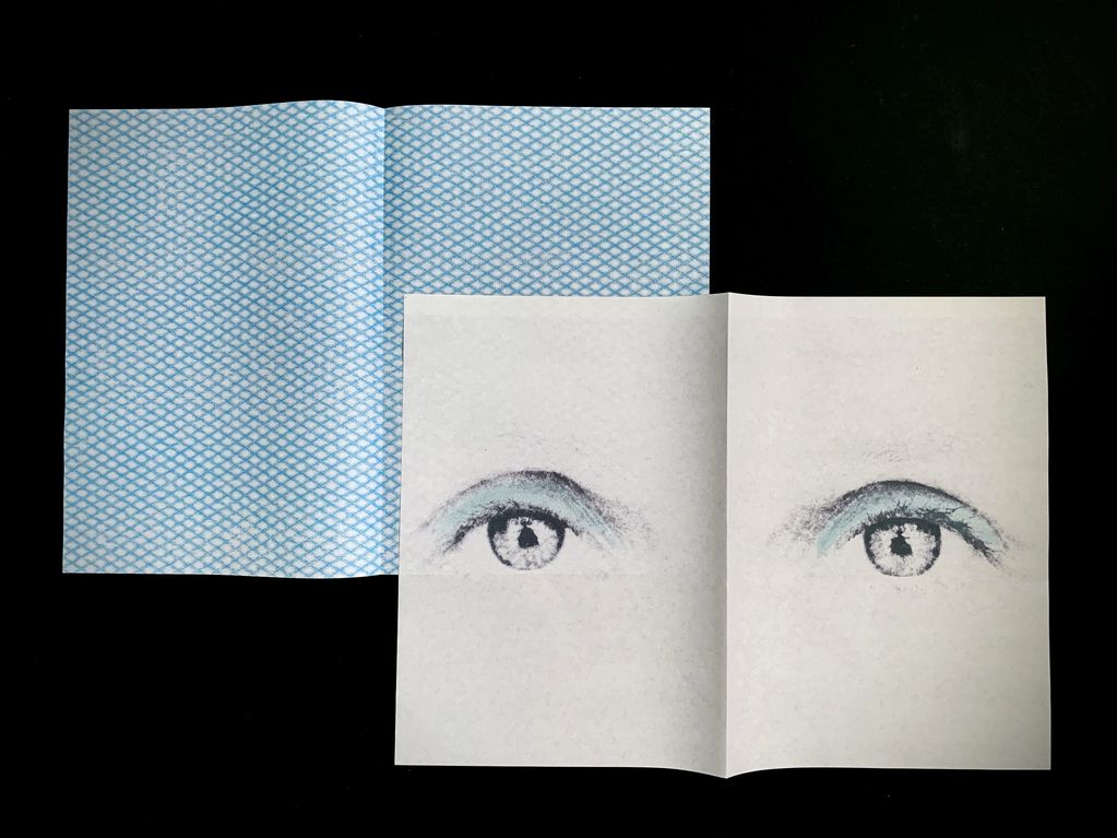 Double spread of eyes and blue paper