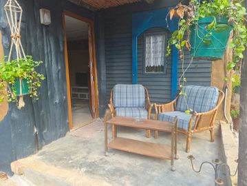 Outdoor seating area with two chairs and a table.