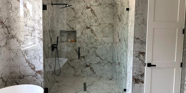 Shower Door with shower tiles with black shower hardware