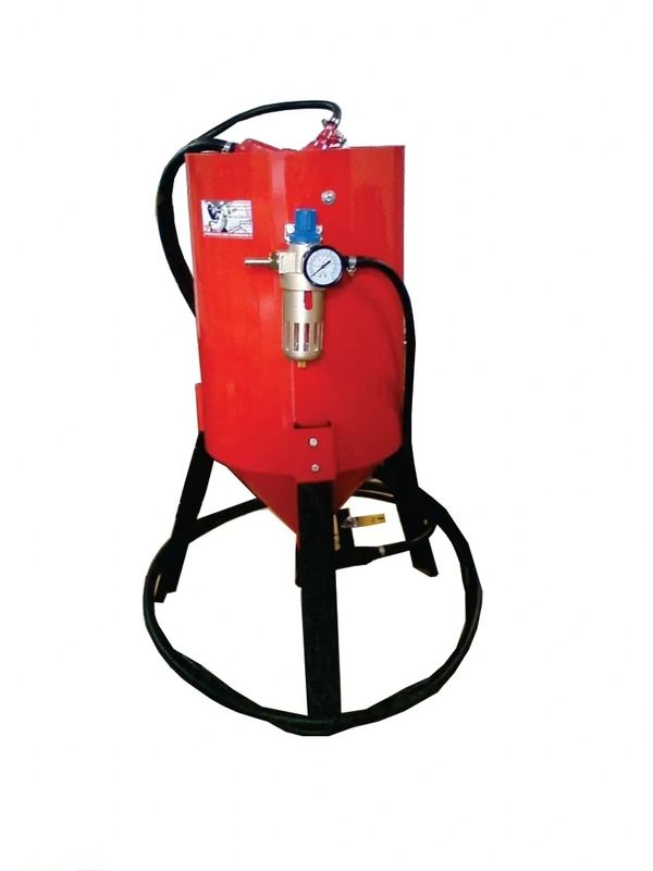 Red industrial sandblasting machine with pressure gauge and hose.