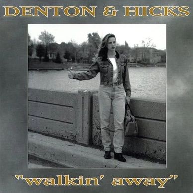 Black and white album cover of a woman hitchhiking by a river.