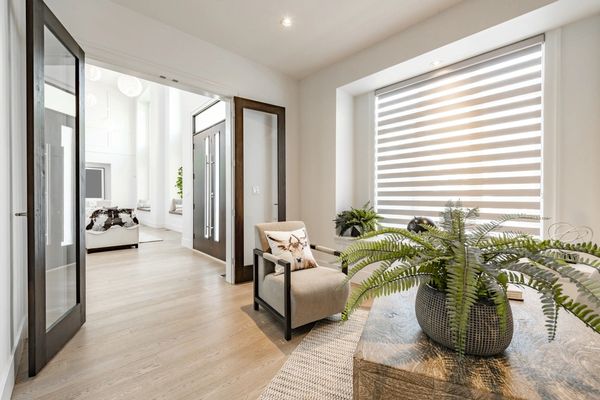 Home office with glass french doors desk globe clock and large windows with blinds