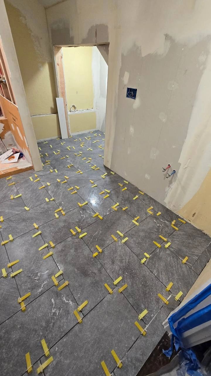 Tacoma bathroom floor tile installation in progress by CHR Construction Group