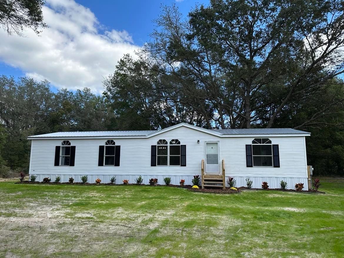 White double wide mobile home ready for removal in Florida