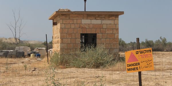 Picture in Israel of a small outpost on the border that is surrounded by a minefield. 